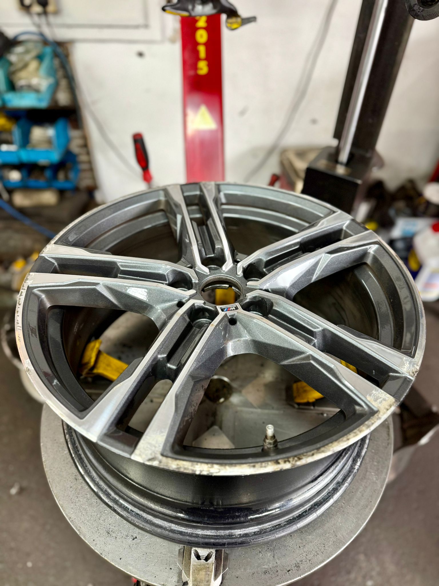 Before — A kerbed, corroded BMW M wheel cut back on the lathe for that bright machined face and refinished in gunmetal. — Burnley