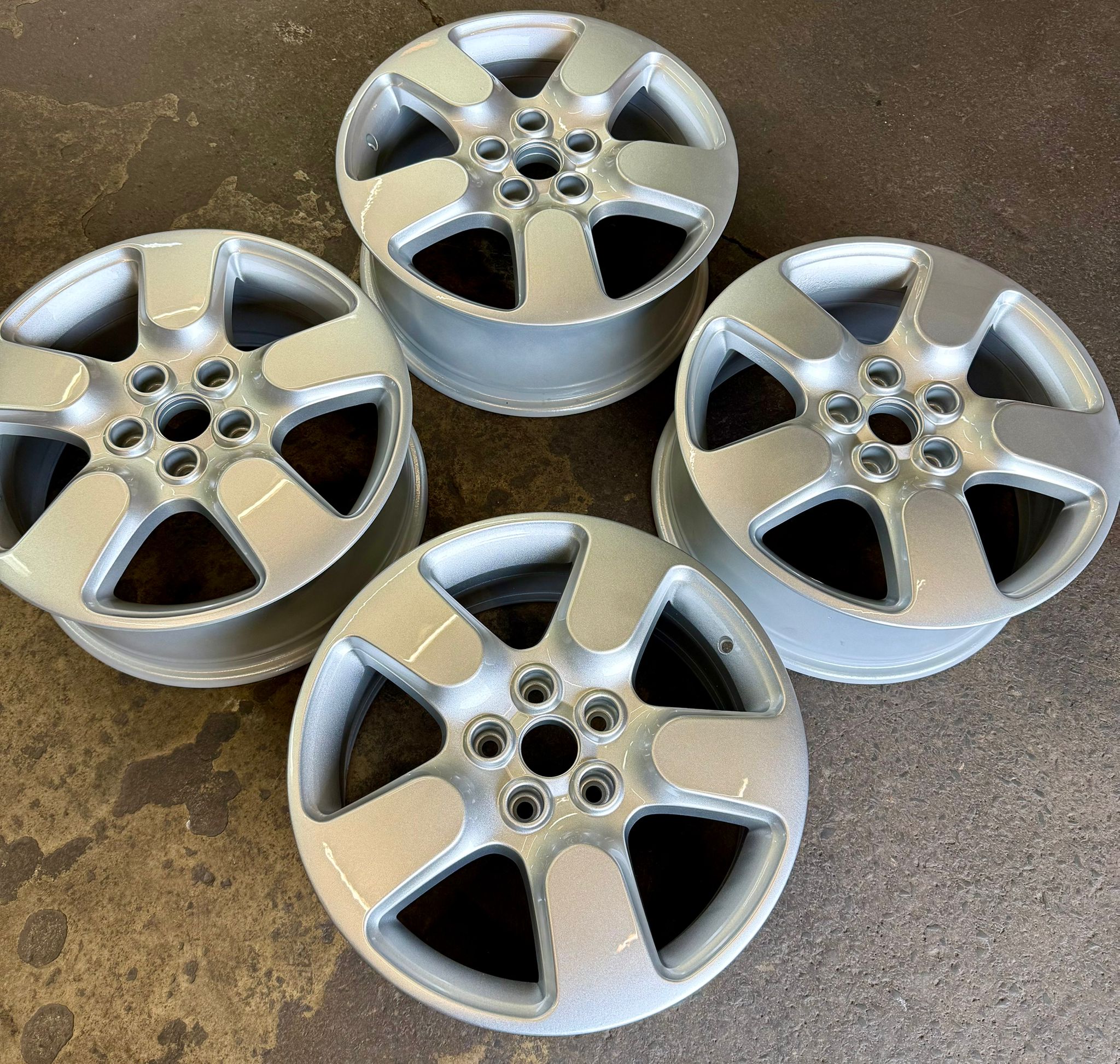 A full set of alloys refurbished and powder-coated in a fresh factory silver